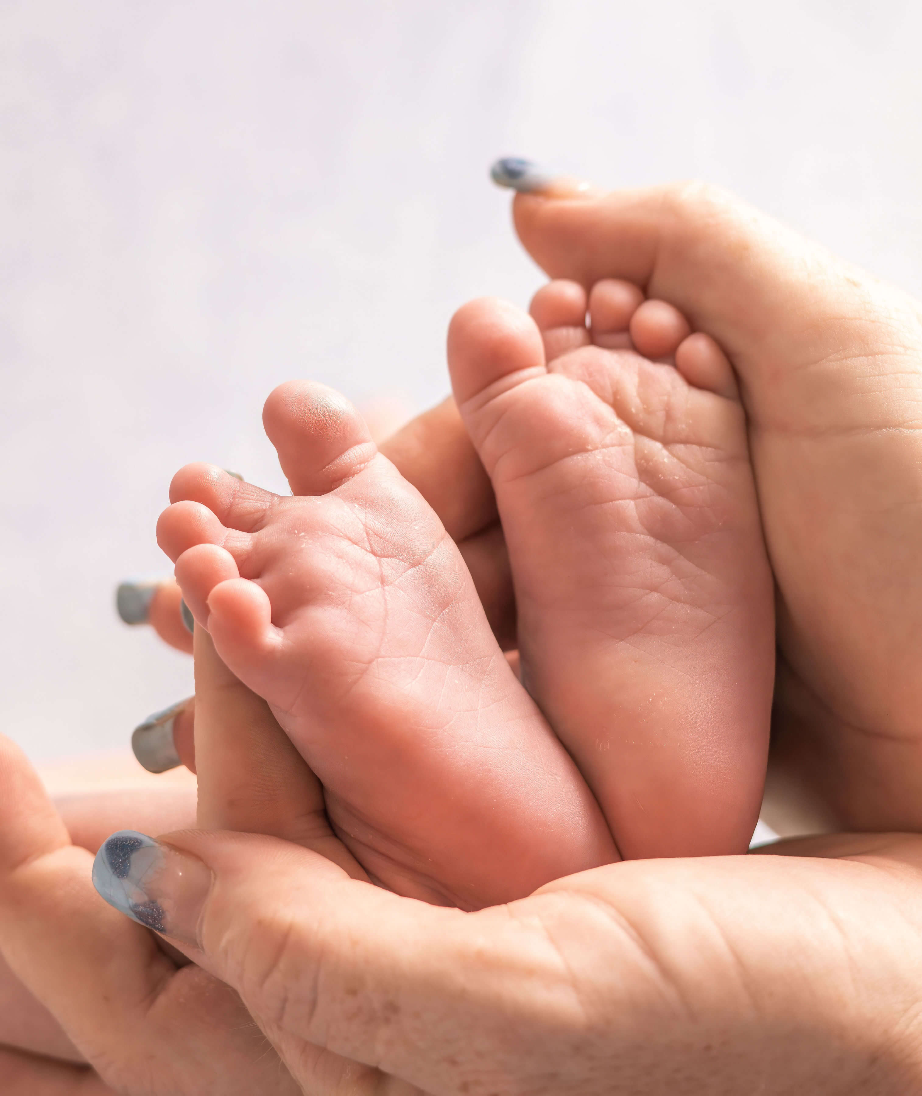 a babies feet being held by hands